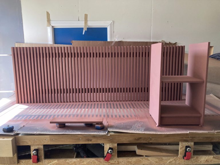 Radiatorombouw met houten latten in de werkplaats voor installatie, terracotta geschilderd — Senders Meubelmakerij